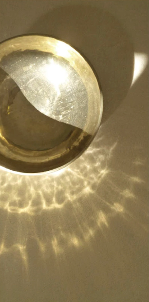 Reflected golden light from a brass bowl