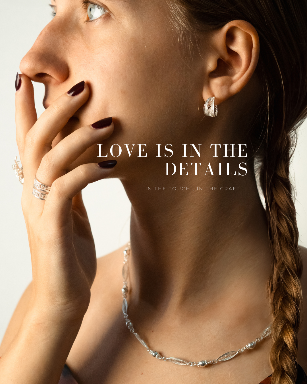 Woman in profile with filigree earring, stacked rings and necklace, titled Love is in the details